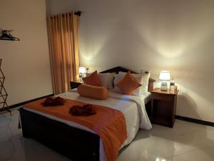a bedroom with a large bed with two towels on it at Erene Inn in Ella