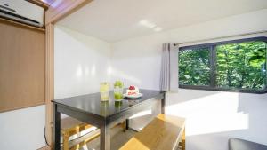 a small dining room with a table and a window at Gapyeong Karabankaempingnongwon in Gapyeong