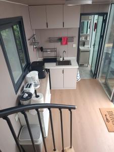 a kitchen with a sink and a counter top at Halte aux randonneurs in La Possession +6 photos
