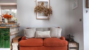 a red couch sitting in a living room at Filly Island in South Cerney
