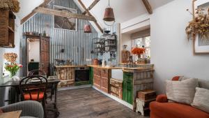 a kitchen with a table and a counter with a stove at Filly Island in South Cerney