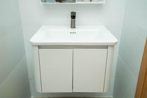 a white bathroom sink with a white counter top at Dimori homestay in Hue