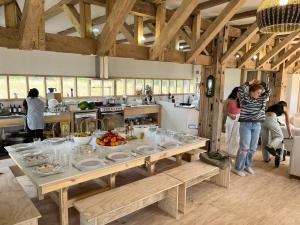 a group of people in a kitchen with a table at Refugio del Sur, Escapada in Llanquihue