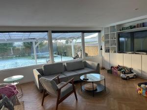 a living room with a couch and a table at Large townhouse Odense in Odense