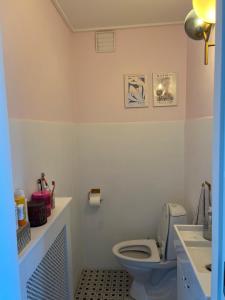 a bathroom with a toilet and a sink at Large townhouse Odense in Odense +4 photos