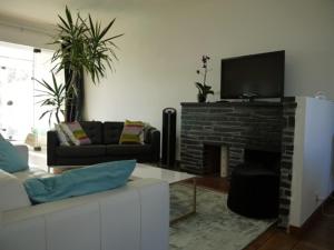 a living room with a couch and a fireplace at Maison Ville - Plage - Concarneau in Concarneau +9 photos