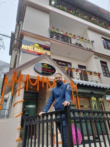 a man standing on a fence in front of a building at Hotel Paryatak in Namchi