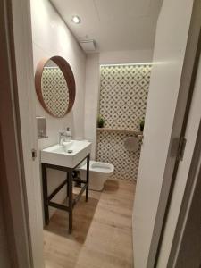 a bathroom with a sink and a toilet and a mirror at Onefam Sants in Barcelona +20 photos