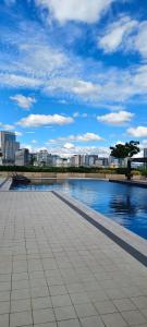 a large pool of water with a city in the background at New Cozy Studio Apartment in Cebu City