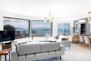 a living room with a couch and a television at Villa Azure Heaven in Turgutreis