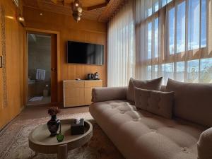 a living room with a couch and a tv at Palais Elya in Rabat