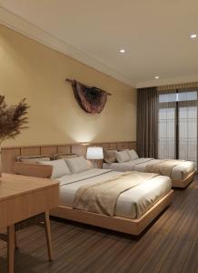 a bedroom with three beds in a room at Voi Meo Vac Hostel & Breakfast in Mèo Vạc