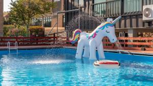 a white unicorn statue in the middle of a pool at Yeongheungdo J Pension in Incheon