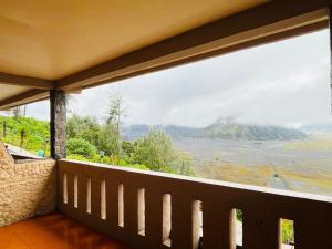 a balcony with a view of a mountain at Cemara Indah Hotel in Bromo