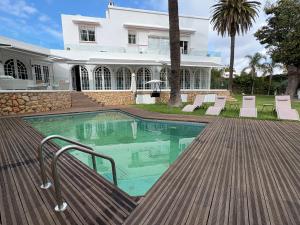 a house with a swimming pool in front of a house at Palais Elya in Rabat