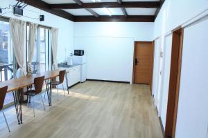 a kitchen and dining room with a table and chairs at 彩の宿月屋 in Yamanakako