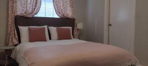 a bedroom with a large bed with a window at The Mews Cottage in Penzance