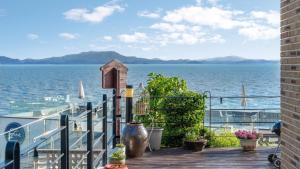a balcony with a view of the water at Yeosu Eoneumeosjinnal Pension in Yeosu