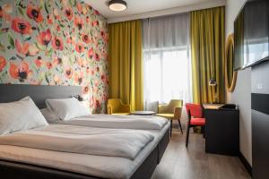 a hotel room with a bed and a flower wall at Thon Hotel Brønnøysund in Brønnøysund +18 photos