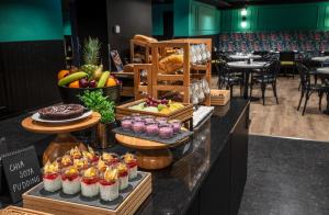 a buffet with fruit and other food on a counter at Thon Hotel Brønnøysund in Brønnøysund