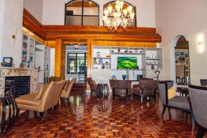 a living room with a fireplace and a table and chairs at Cozy Stead Hotel - Garden House, Gigiri in Nairobi