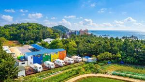 an aerial view of a farm with a train yard at Goseong Jjun Camping Pension in Goseong