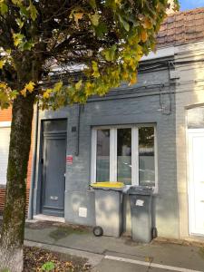 a building with two trash cans in front of it at L'escale Barbieux in Croix