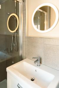 a bathroom with a sink and a mirror and a shower at Tenuta Mastro in Sulmona