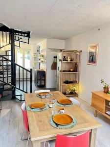 a dining room with a wooden table and red chairs at L'escale Barbieux in Croix