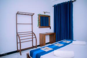 a room with a bed and a mirror and a ladder at Coco Leaf Apartment with Private Pool Near the Beach in Hikkaduwa
