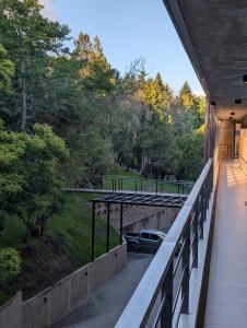 a balcony of a house with a car on a field at Amanecer del lago in San Carlos de Bariloche