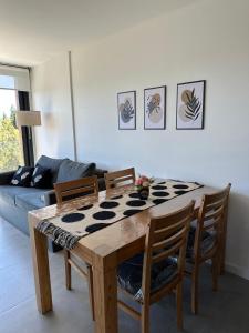 a living room with a wooden table and chairs at Amanecer del lago in San Carlos de Bariloche +37 photos