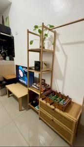 a book shelf with a bunch of beer cans at Ellain's Cozy Staycation-SMDC Green 2 Residences in Dasmariñas
