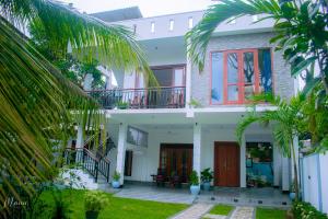 a view of a house from the garden at Coco Leaf Apartment with Private Pool Near the Beach in Hikkaduwa