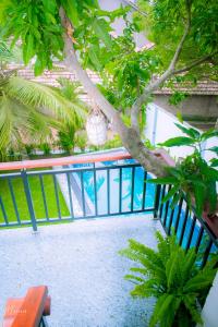 a staircase with a tree and a blue railing at Coco Leaf Apartment with Private Pool Near the Beach in Hikkaduwa