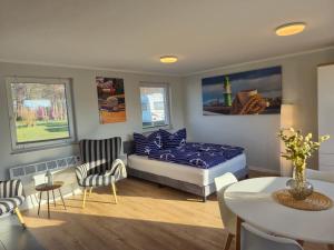 a bedroom with a bed and a table and chairs at Ostseecamping am Salzhaff in Pepelow