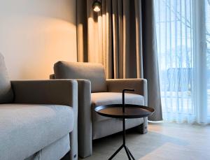 a living room with two chairs and a table at Quartier 90 in Wietmarschen