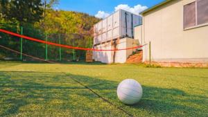 a soccer ball sitting on a field next to a building at Geojedo Pilos Ocean View Pension in Geoje +1 photo