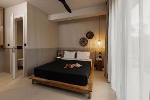 a bedroom with a bed and a clock on the wall at Terra Mare Villas in Ialysos +42 photos