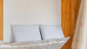 two pillows sitting on top of a bed at Ganghwa Herb Pension in Incheon