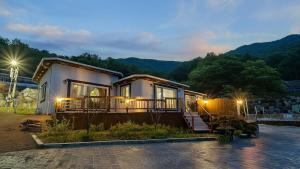 a house with a porch and lights on at Ganghwa Herb Pension in Incheon
