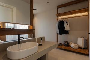 a bathroom with a white sink and a mirror at Terra Mare Villas in Ialysos