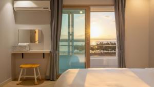 a bedroom with a bed and a view of the ocean at Sokcho pensionbyeol in Sokcho