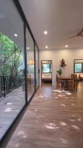 a living room with glass doors and a dining room at Ganesha Mouse House in Ko Phangan