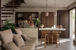 a woman standing in the kitchen of a house at Terra Mare Villas in Ialysos