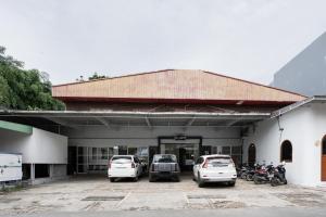a group of cars parked in a parking lot at Urbanview Hotel Cozy Samarinda by RedDoorz in Samarinda