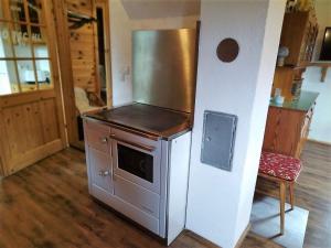 a kitchen with a refrigerator and an oven at Götschlhütte in Bad Sankt Leonhard im Lavanttal
