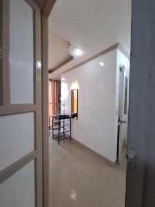 a door leading to a hallway with a table in a room at Imari's Apartment in San Isidro