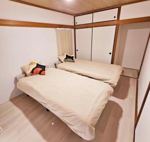 a small bedroom with two beds in it at Itoshima STAY YAMAGA Keya in Itoshima +15 photos