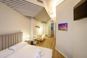 a bedroom with a bed and a desk in a room at Residence Concordia in Gorizia